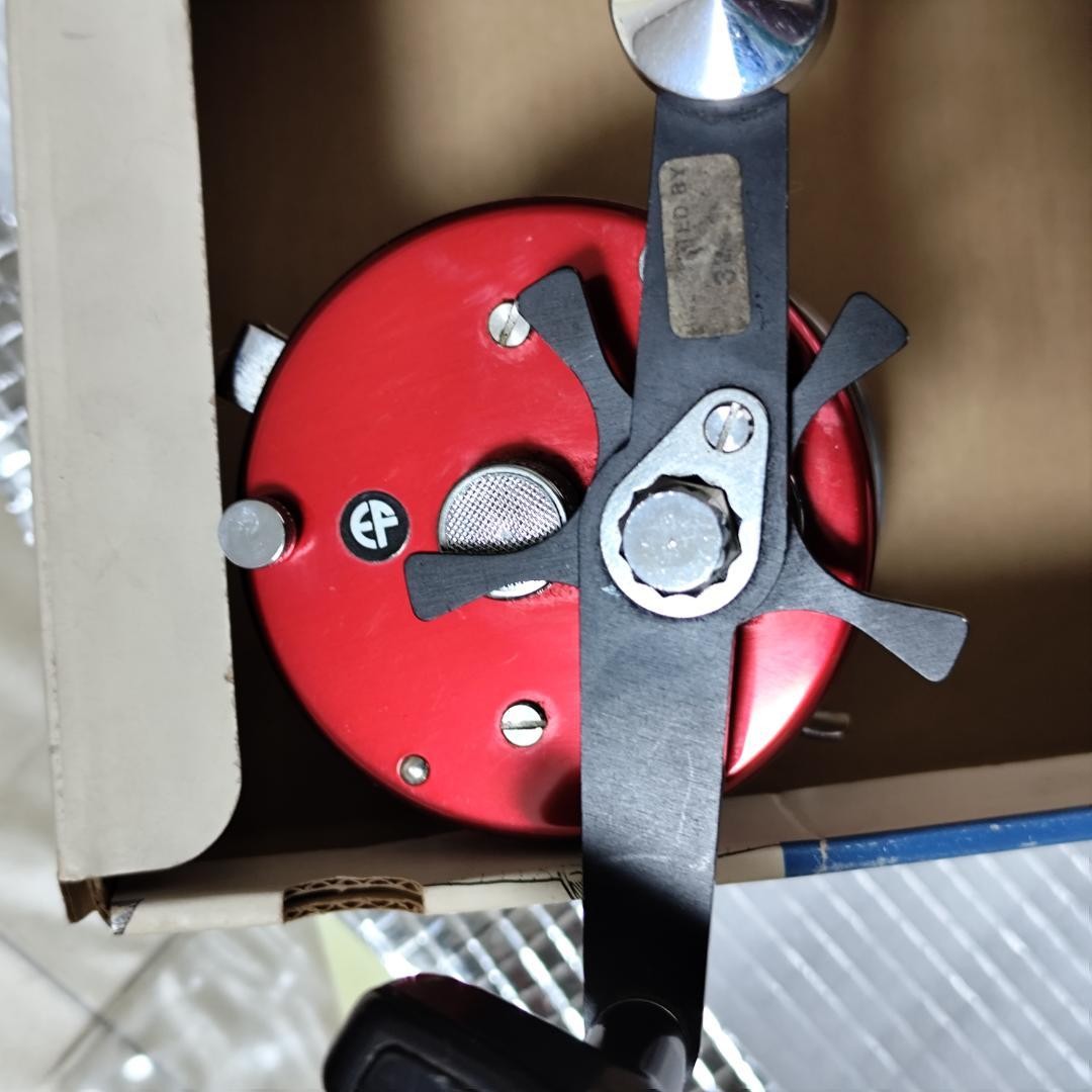 Abu Garcia ABU Ambassador 7000 Red with box, instruction manual, and user’s