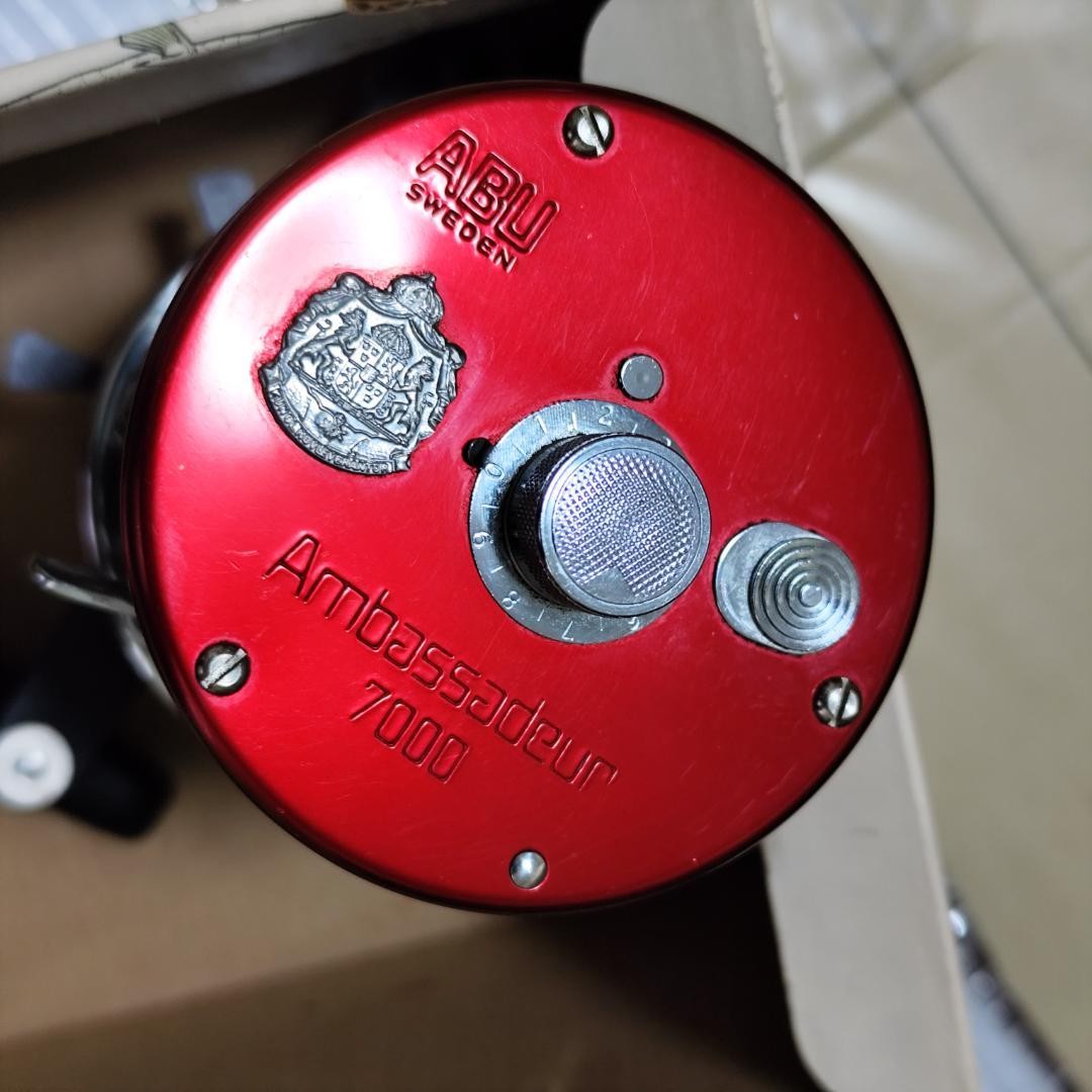 Abu Garcia ABU Ambassador 7000 Red with box, instruction manual, and user’s