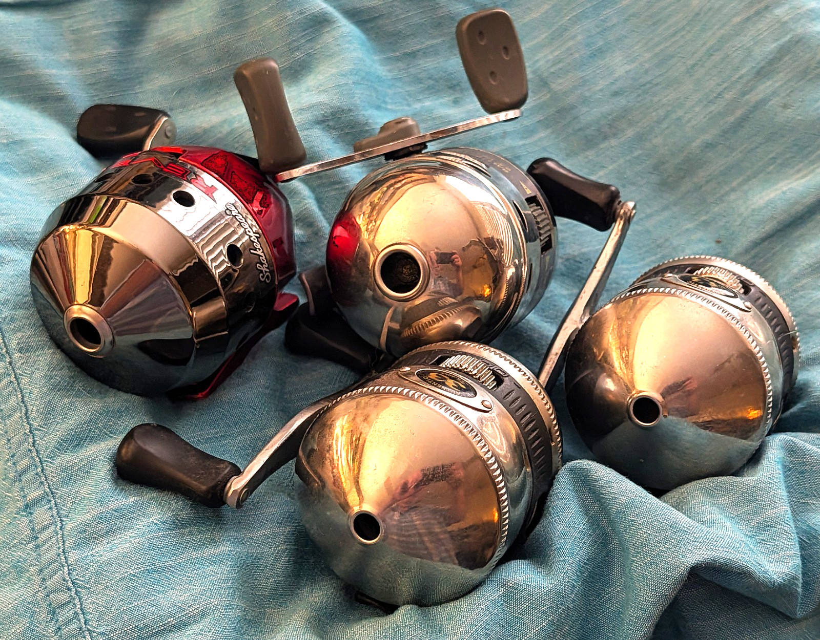4 Spincast Reel lot: 2 Zebco 33’s, 1 Photon, and 1 Shakespeare Reverb