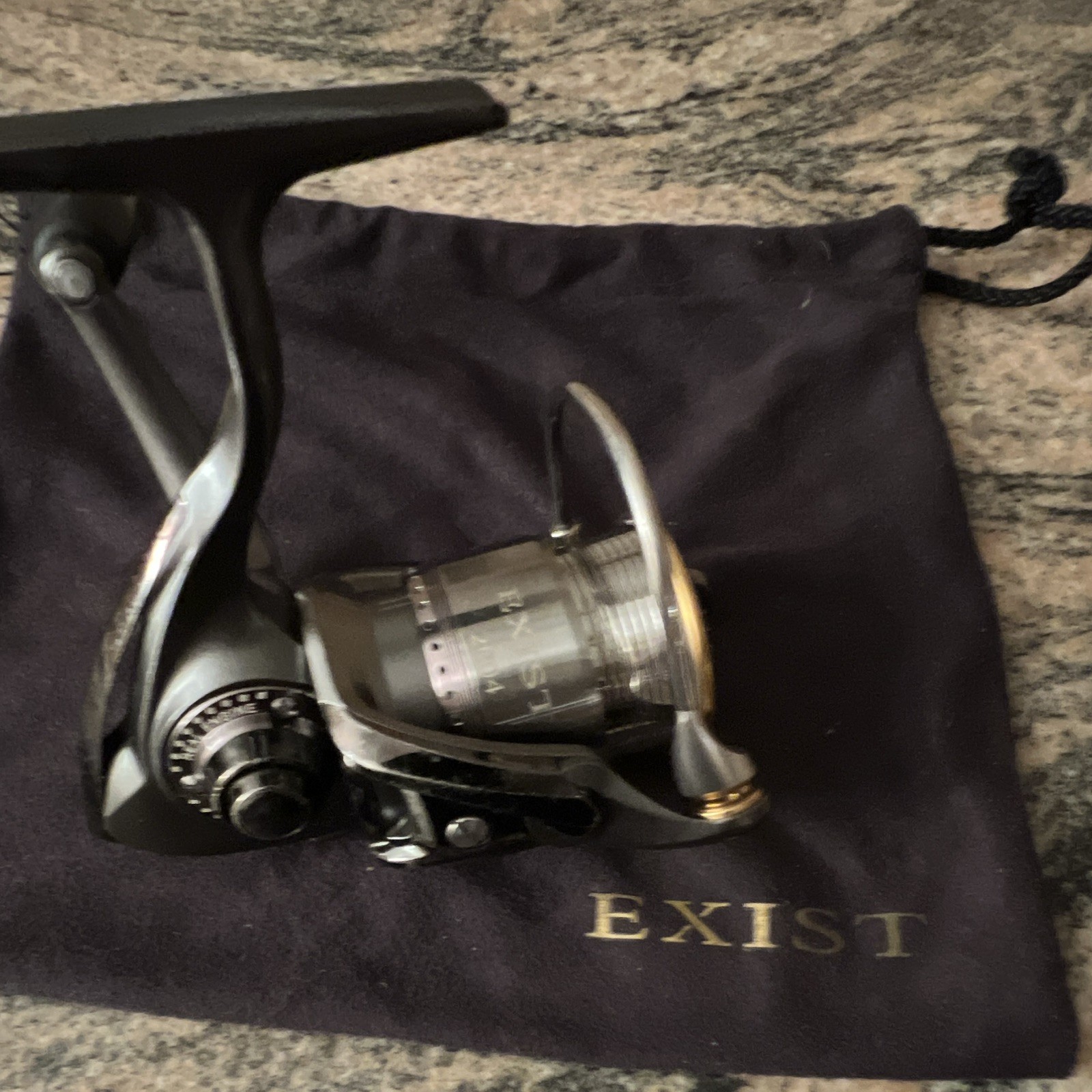 Daiwa Exist 2004 Black/Silver Spinning Reel 4.1:1 12BB Front Drag w/ Pouch